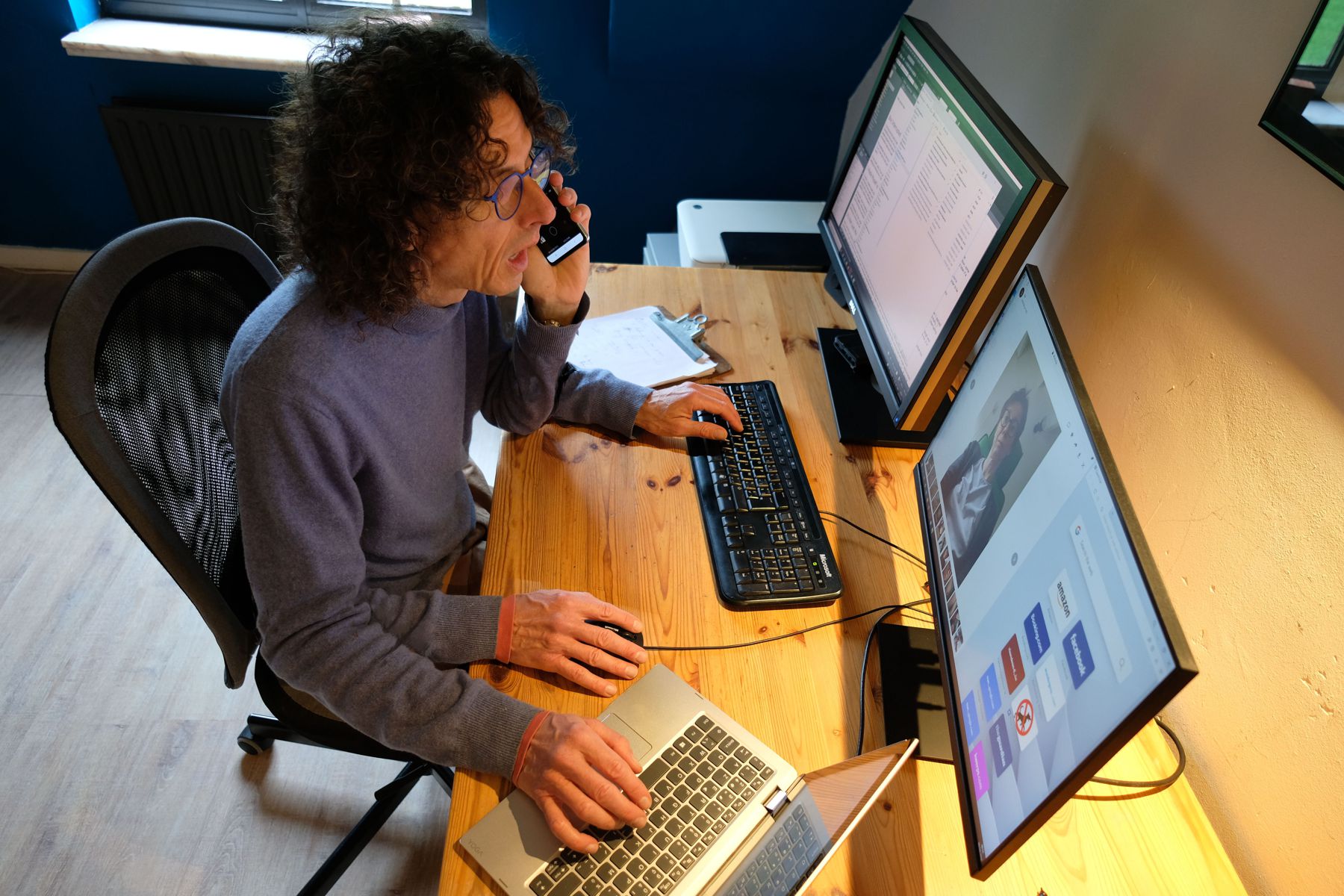 Jeffrey, with four hands, working at desk